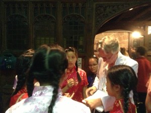 Charles Bennett signing scripts for choir members from Hong Kong.